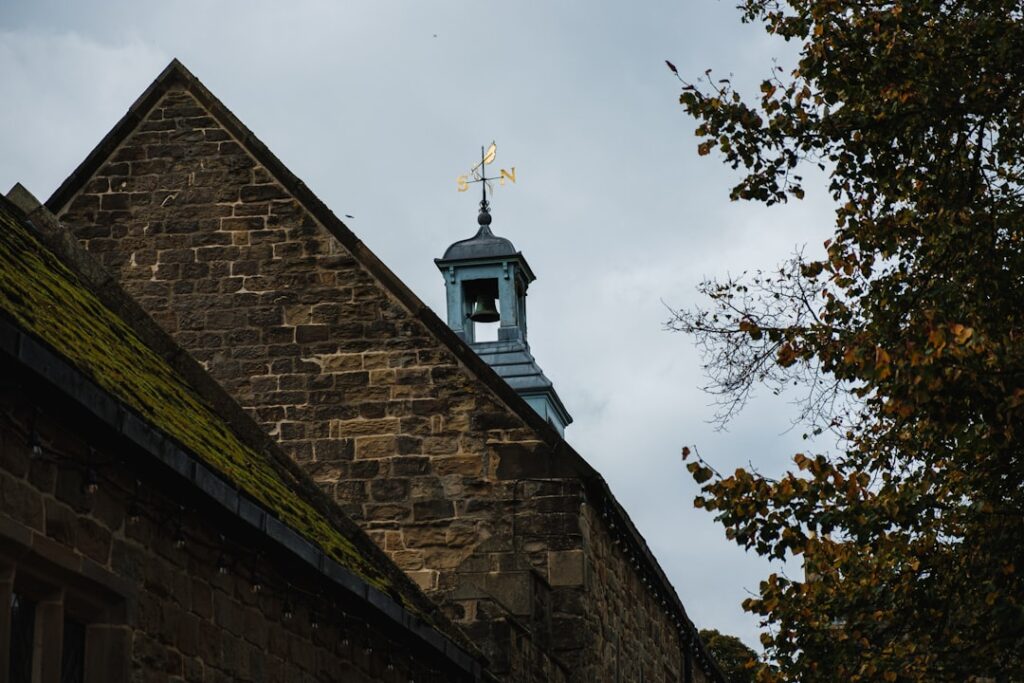 a church steeple with a weather vane on top