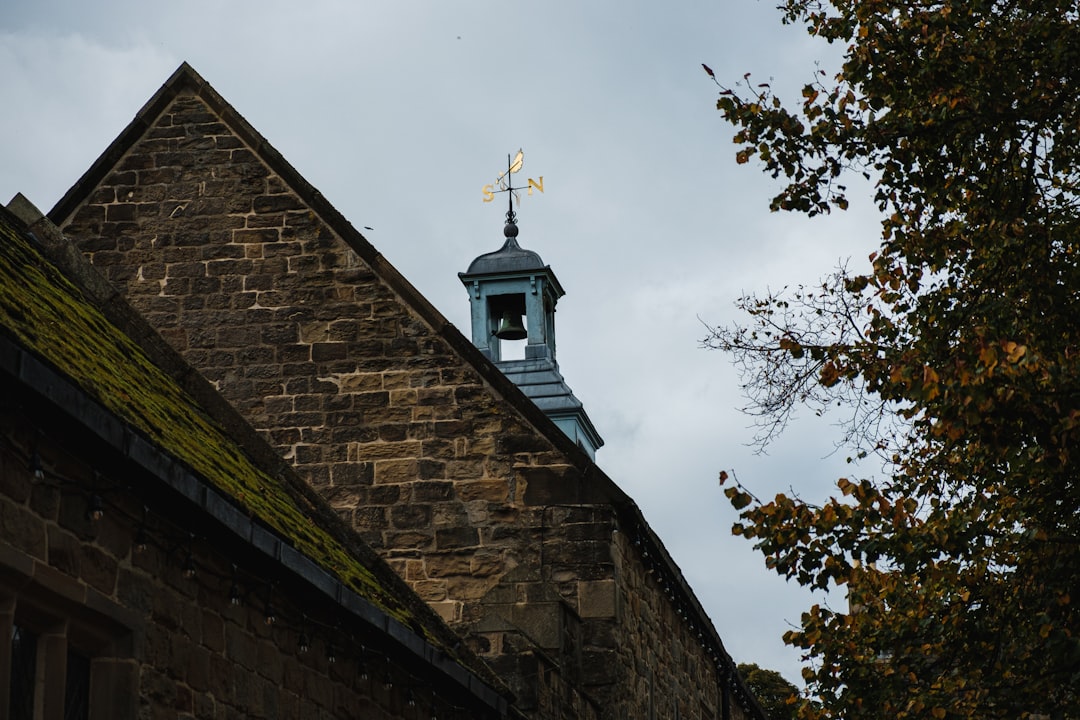 a church steeple with a weather vane on top