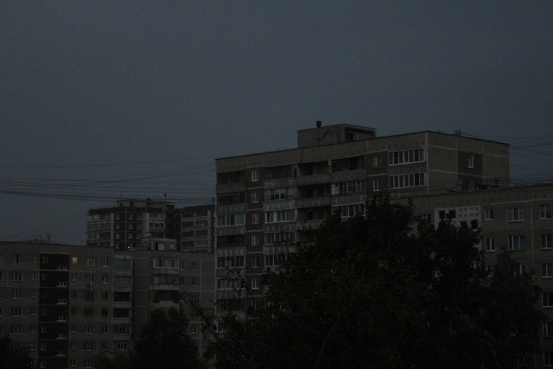 a full moon in the sky over a city